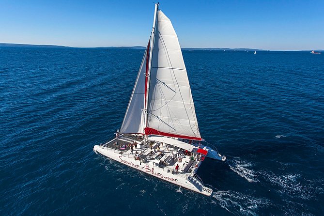 Blue Lagoon, Trogir & Čiovo catamaran tour with Food and Drinks - Onboard vibe: drinks all day, music, and a party mood