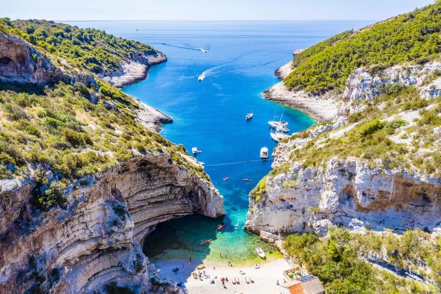 From Hvar: Blue Cave, Green Cave & 5 Islands Speedboat Tour - Stiniva Cove on Vis: cliff views, a swim, and photo slopes