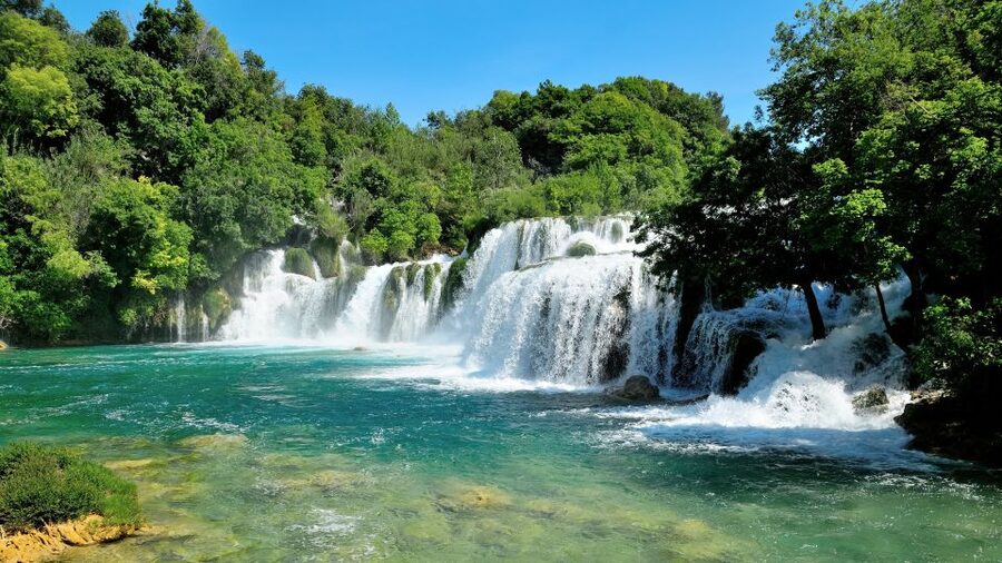 Split: Krka National Park Day Trip with Boat Ride & Swimming - Skradin beach time: swimming, pebble comfort, and what to do with one hour