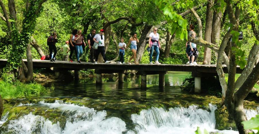 Split: Krka Waterfalls With Boat Cruise, Wine and Olive Oil - Skradinski buk waterfalls: travertine cascades and wooden walkways