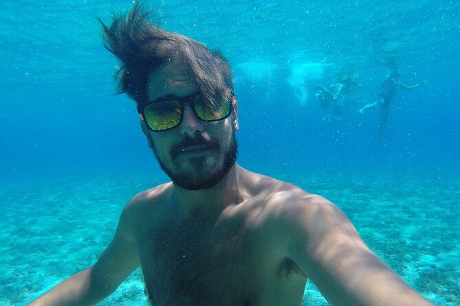 Two Islands Blue Lagoon Half-Day Boat Tour from Split - Stop One: Krknjasi Bay and the Blue Lagoon snorkeling hour